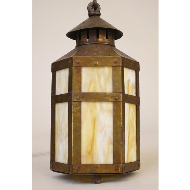 A dramatic and sculptural Mission style Chimney topped fully contained lantern shaped form hanging pendant swag style lamp...
