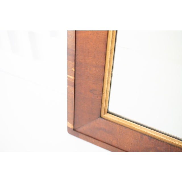This listing is for a vintage, mid-century wall mirror. It is made of heavy, hard wood with gold trim surrounding the...