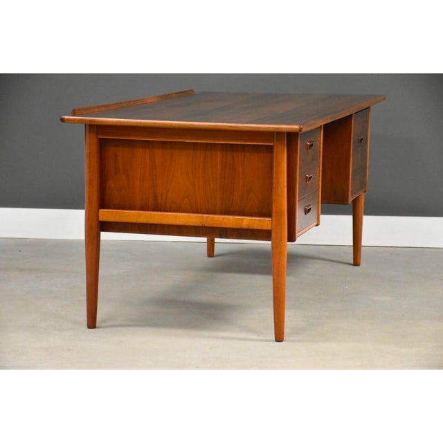 A mid century modern teak floating desk designed by Goran Strand for Lelangs Mobelfabrik with a drawer with the capability...