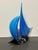 Add a touch of coastal elegance to your décor with this handcrafted blue sailboat art glass sculpture by Dale Tiffany....