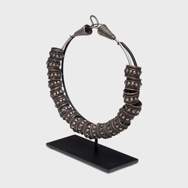 This intricate silver necklace was once a part of the elaborate attire of a Miao women in southwest China, an ethnic...