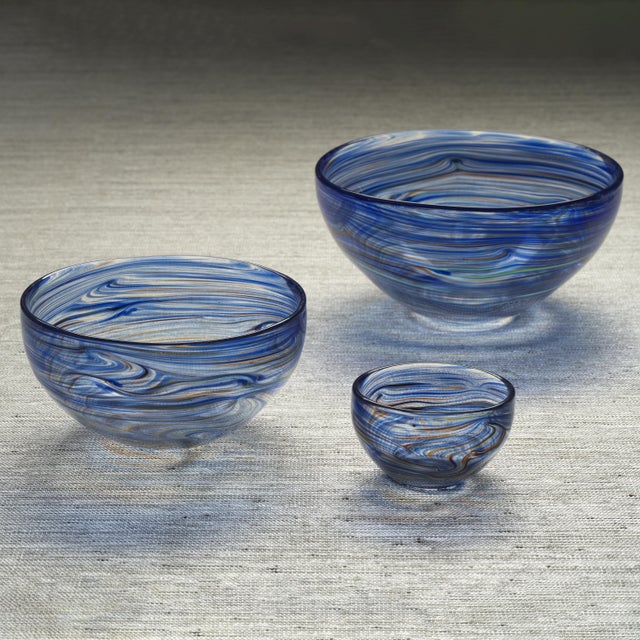 The Delphine Glass Serving Bowl showcases a stunning blend of color with its vibrant swirl design that covers the entire...