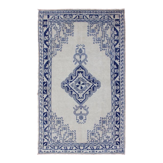 Vintage Turkish Oushak Rug Featuring Deep Indigo and Ivory Geometric Medallion For Sale
