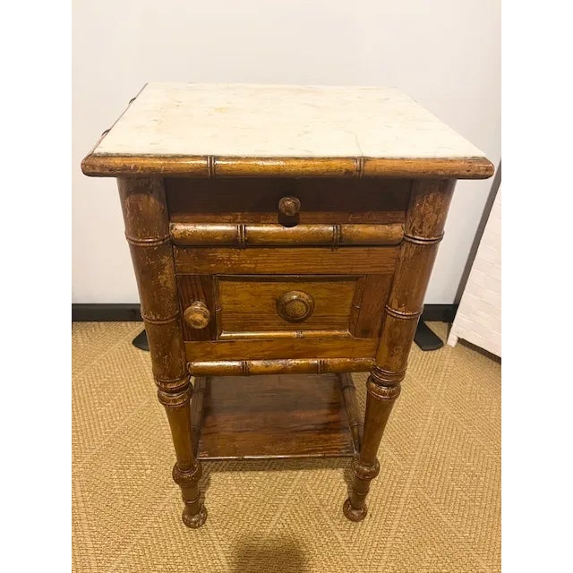 In the style of Art Nouveau period in France, a charming side table with inset rectangular white marble top, a dove tailed...