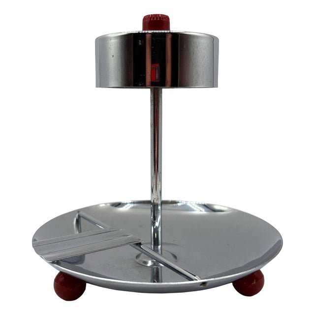 Early mid-century ashtray features a polished chrome finish with a wide circular base tray and a vertical center column...