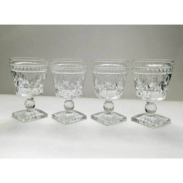 A beautiful set of vintage geometric pattern square based goblets in a clear glass that compliments a variety of settings.
