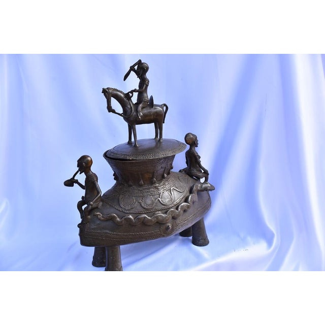 The Dogon people, who live in Mali, are renowned for their rich artistic and cultural heritage. The bronze ointment jar...