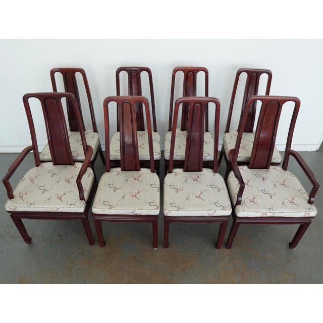 A striking vintage set of eight dining chairs featuring elegant Asian-style design elements, tall sculptural backs, and a...