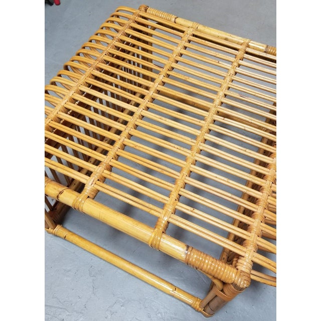 Restored rattan and pencil reed ottoman footrest featuring a top that scrolls into the side of the stool in the style of...