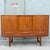 A beautifully crafted Scandinavian Modern teak credenza featuring a warm, richly grained teak veneer and clean...