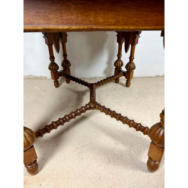 Handsome Spanish dining table crafted in wood, featuring turned baluster legs, carved details, and distinctive barley...
