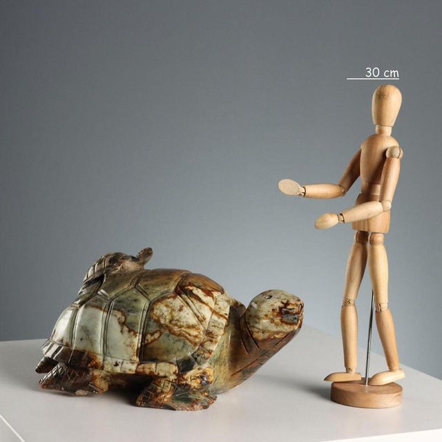 Hard stone sculpture depicting a mother turtle with her baby on her back. This piece is attributed to the mentioned...