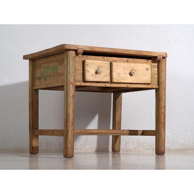 Rustic kitchen table in pine wood with two front drawers, originating from the alpine central european tradition and dated...