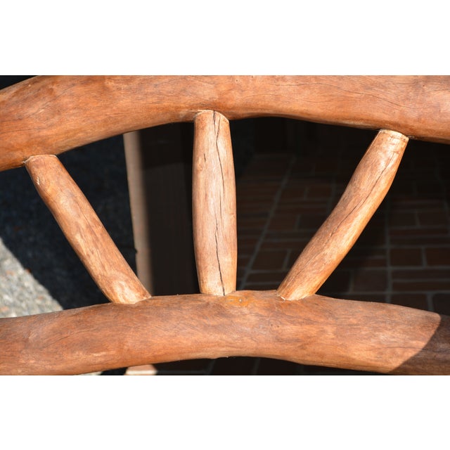 What a unique piece! Handcrafted of solid wood. Single bench seat. Solid & heavy. The seat interior is between the arms in...