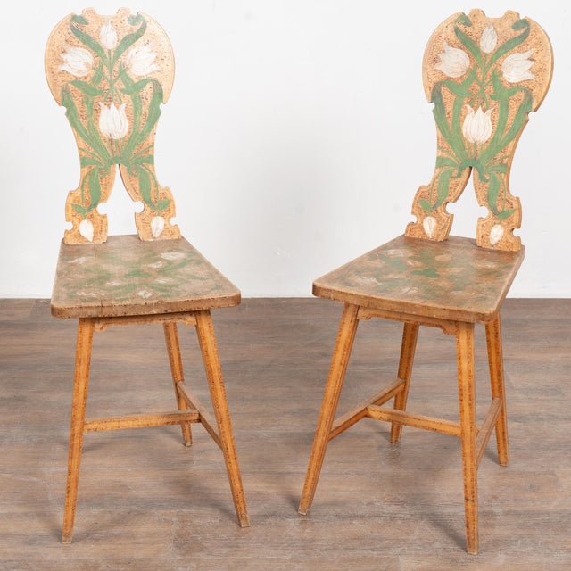 Early 20th-century Swedish folk art set consisting of one small side table and two chairs, all crafted from pine and...