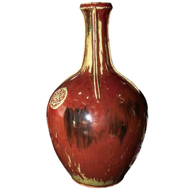 This commanding 18-inch tall Chinese-style bottle vase is a bold decorative statement, finished in a rich flambé oxblood...