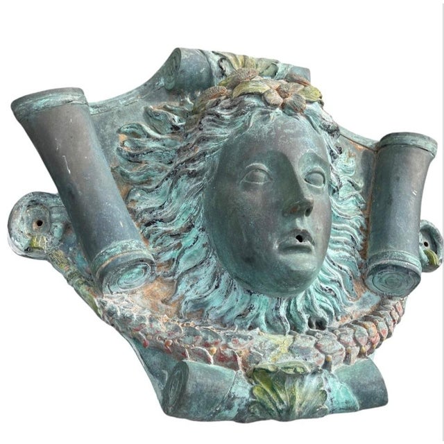 Exquisitely cast in the Neoclassical style, this Italian bronze wall fountain spout—or mascaron—features the serene,...