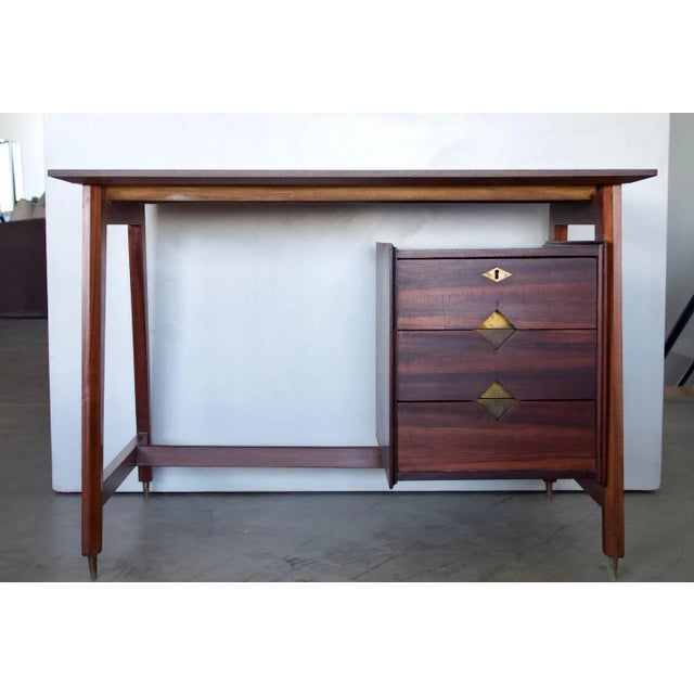 Writing desk with brass details, made in Italy, circa the 1960s. The desk has been partially restored and has a tabletop...