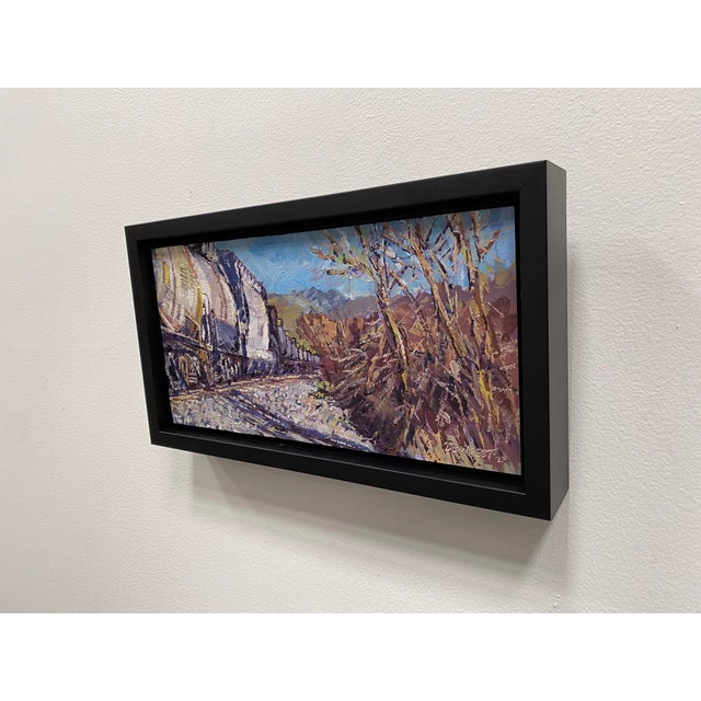 This oil on panel artwork captures the vibrant hues of fall in a landscape where industrial elements meet nature. The...