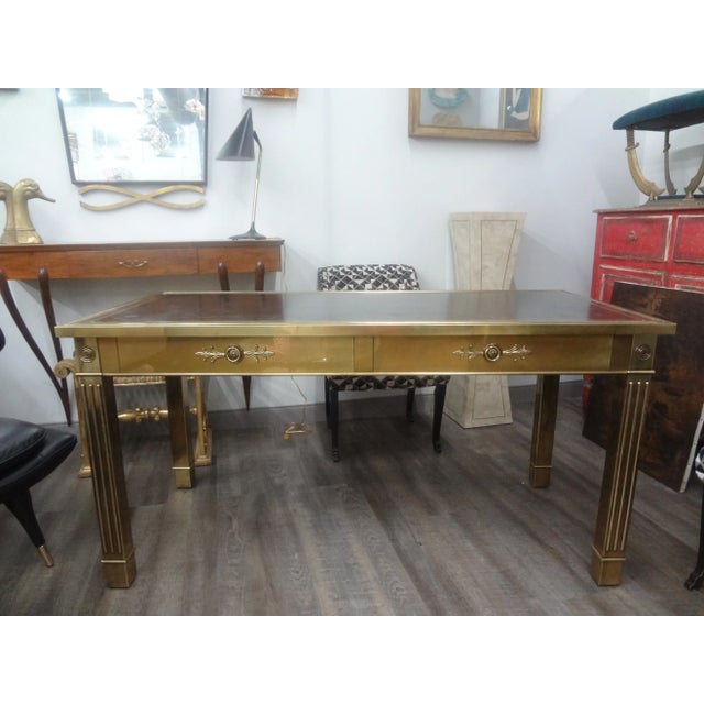 Iconic Mastercraft Brass Desk With Leather Top. Stunning large mid century brass desk or writing table by Mastercraft....