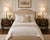 A beautifully refined pair of French Provincial bombe nightstands, thoughtfully elevated with satin black tops and fine...