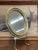 Oval shaped small wall Mirror with gold toned painted wood framing. Stand not included. Vintage Condition Consistent with...