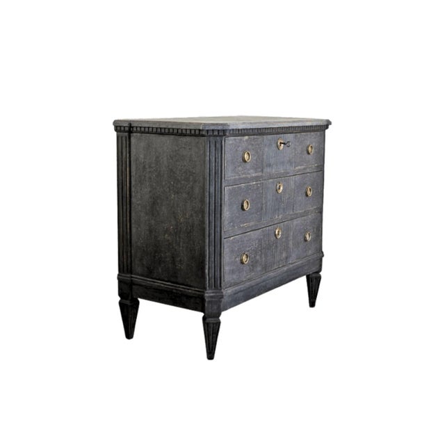 A striking 19th century Swedish Gustavian style commode featuring a richly layered ebonized patina with subtle charcoal...