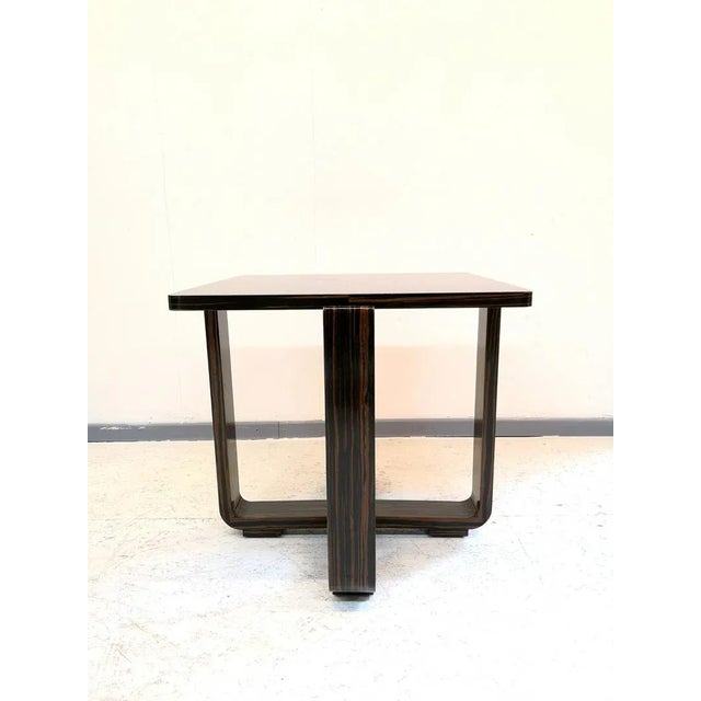This ebony macassar table features a hand-polished french varnish in a high gloss finish.