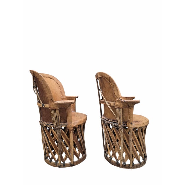 Vintage Native American Leather and Wood Chairs - Pair This unique pair of vintage North or Native American leather and...