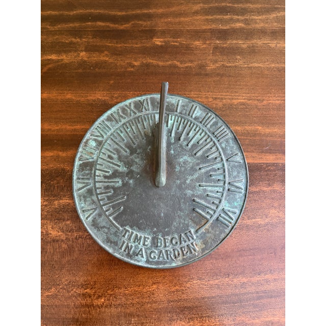 A stunning vintage iron verdigris garden sundial reading "Time Began in a Garden" USA, Late 20th Century Measures: 7.5"W x...