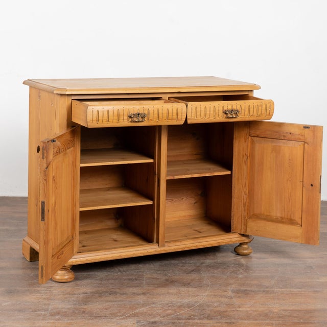 19th-century pine sideboard showcasing traditional fluted carved drawer details commonly found in Danish antiques of the...