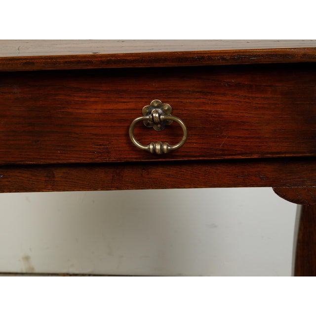 A French Louis XV style walnut desk from the 19th century, with two drawers and cabriole legs. Created in France during...