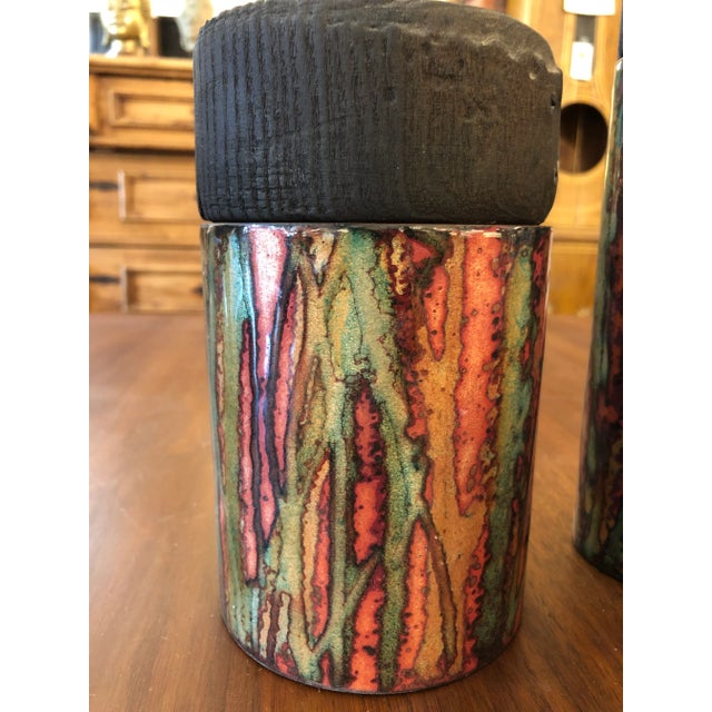 A striking artisan made set of 3 cylindrical copper canisters having gorgeous shiny abstract glazing with marvelous...