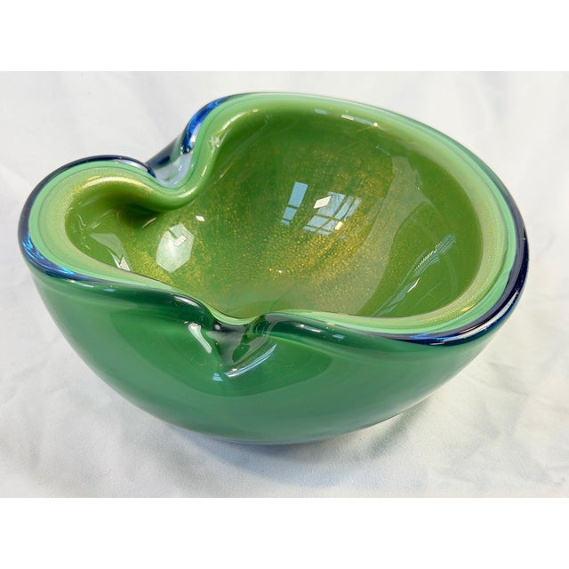 This is a gorgeous mid-century art glass bowl in a rich emerald green with suspended gold aventurine flecks. The bowl...