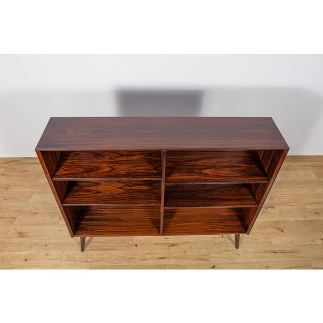The shelf made of rosewood in Denmark in the 1960s. The shelf has interesting graining and profiled edges. Possibility to...
