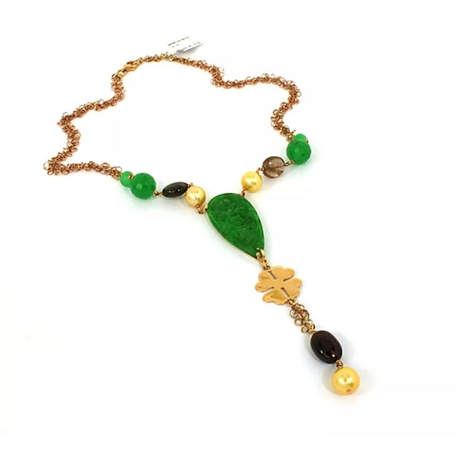 This Leaderline necklace is crafted from 18k rose gold featuring a beaded and carved jade centerpiece with pearls an...