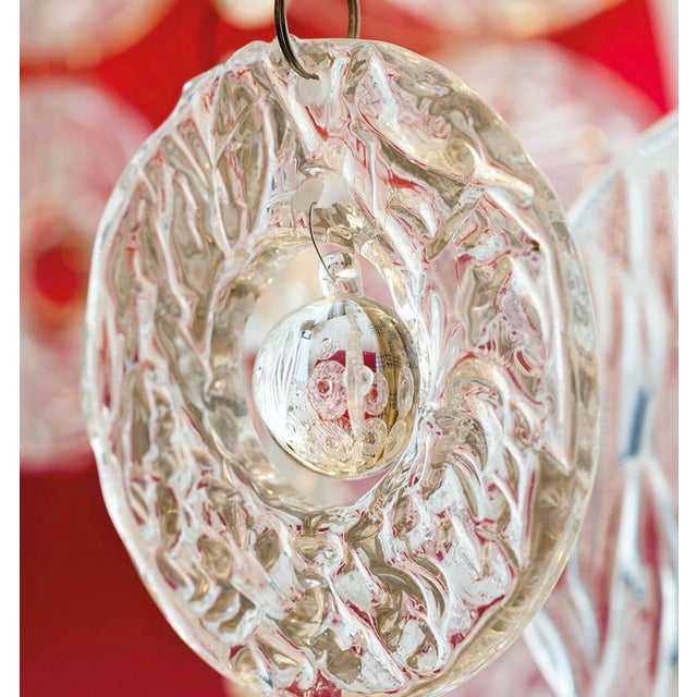 **TWO AVAILABLE** This chandelier is both striking and contemporary in its design. The abstract hand-pressed glass pieces,...