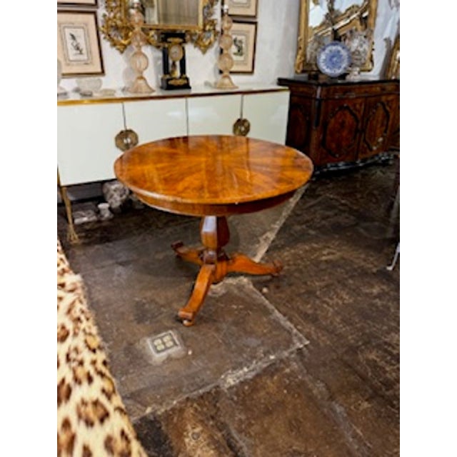 The 19th Century Biedermeier Center Table is a stunning piece of furniture that exudes elegance and charm. This timeless...