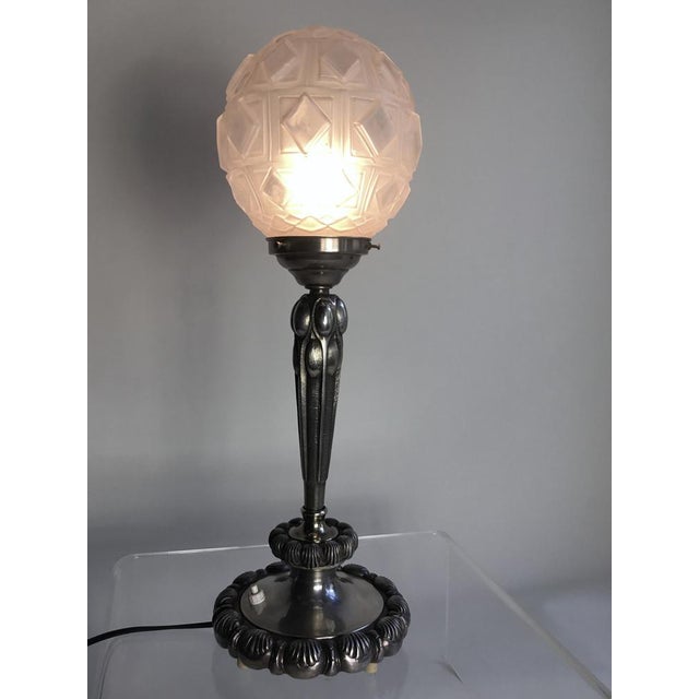 Authentic french Art Deco lamp crafted from nickel-plated bronze, featuring an elegant frosted glass globe shade with...