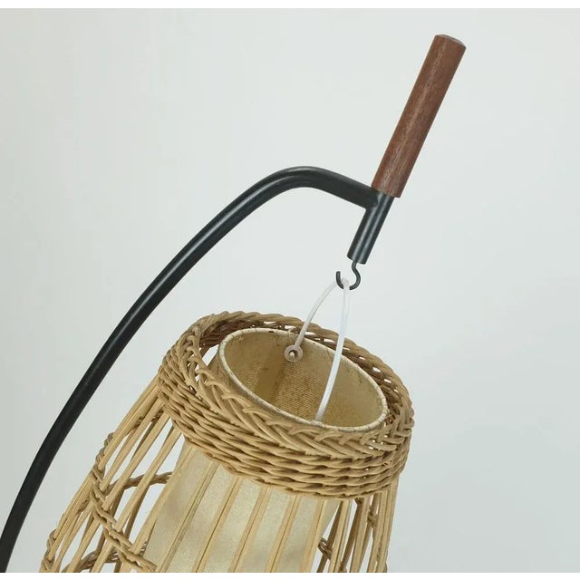 Very unusual and rare floor lamp from the early 1960s. Black painted metal frame with teak wood elements. The base is also...