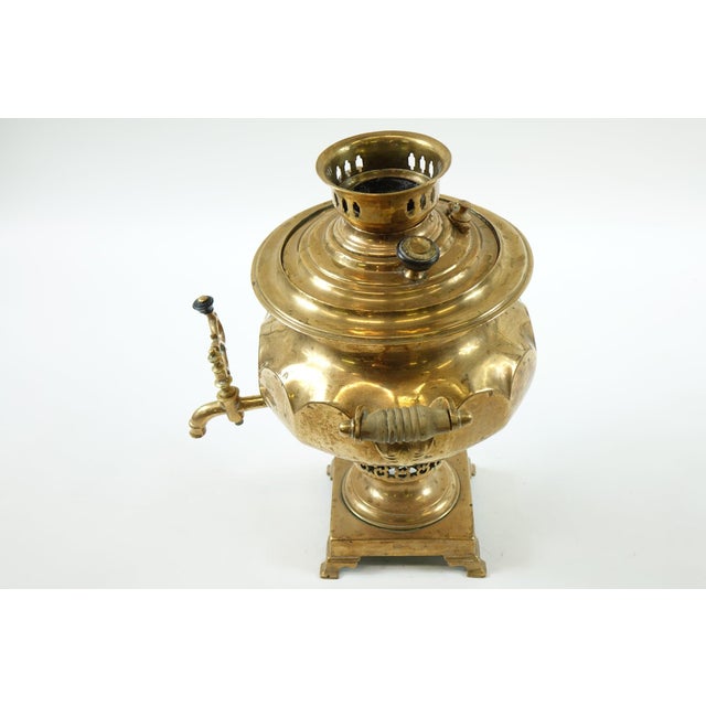 Antique Brass Russian Samovar – 13ʺW × 13ʺD × 16ʺH Experience a piece of Russian heritage with this elegant antique brass...