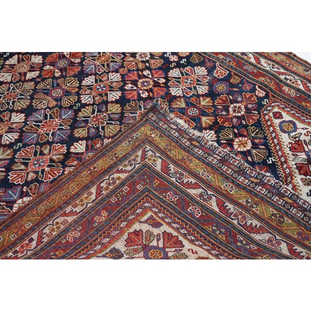 This modern western Turkish town carpet features a five column design of tilted palmettes, symmetrized ragged palmettes...