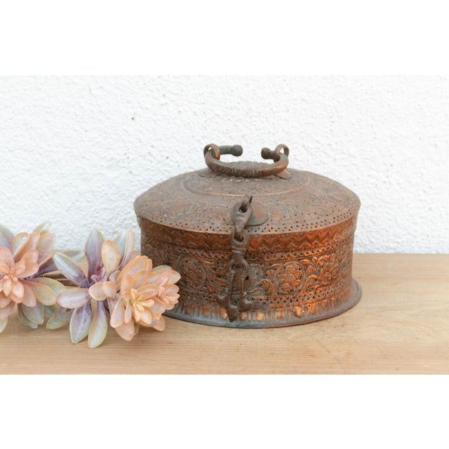 This piece is a tactile treasure map. Every inch of the surface is covered in hand-chased geometric and floral engravings....