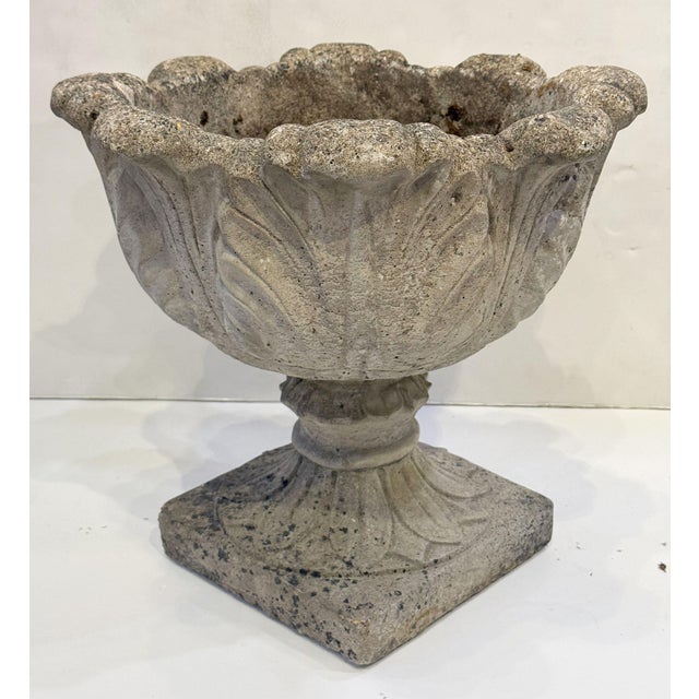 A finely modeled and weathered English garden planter pot or urn of composition stone featuring a beautiful acanthus leaf...