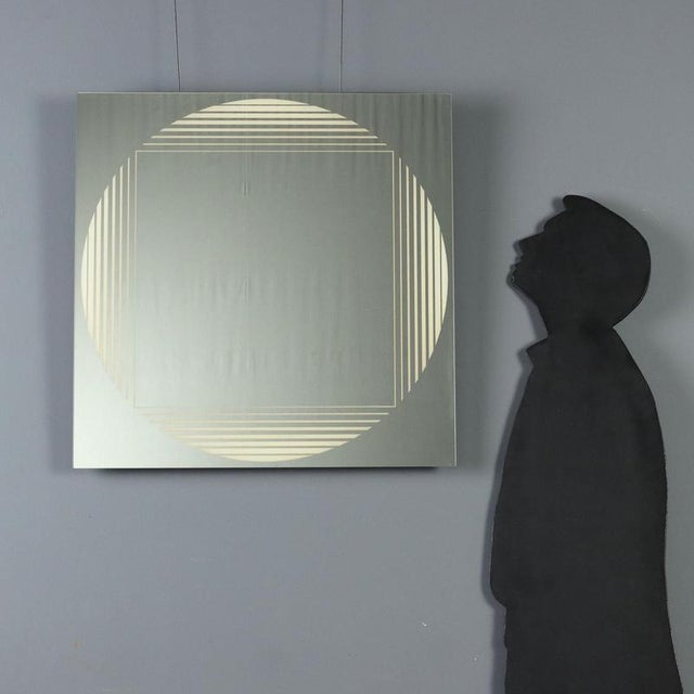 Brama' mirror model designed by Gianni Celada for a 1970s FontanaArte production. Featuring a square shape, the mirror is...