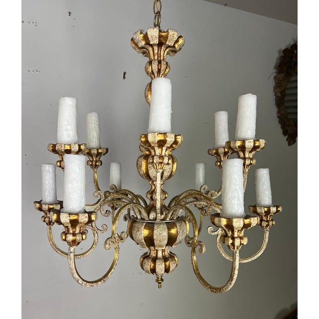 Italian 12 light 1930's Italian Rococo-style chandelier. It features a cream painted finish with gold leaf accents. The...