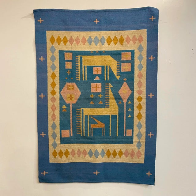 Large mid-century modern tapestry with an abstract animal/forest scene. It has great colors of blue, pink, and yellow. It...