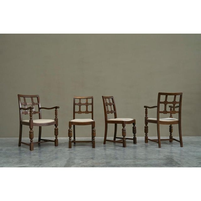 A beautiful set of four dining chairs in solid oak and velvet. France, 1940s. An expressive set of four French dining...