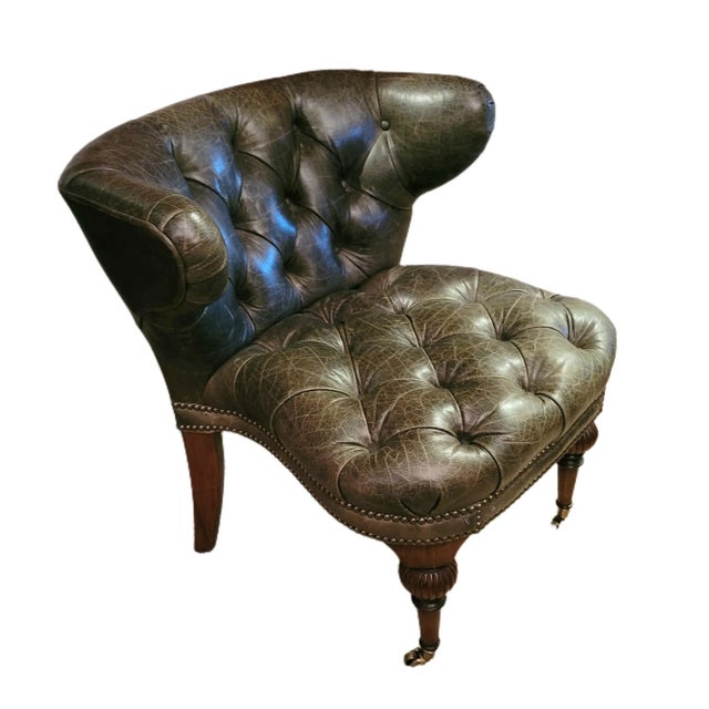 Victorian Tufted Leather Cockfighting Chair, with pleated, deep button back and arms. The stuff-over seat with piping and...