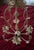 White iron Wendy Bellissimo Teaberry 22in chandelier with 4 candle style lights and leaf/flower accents. Includes original...